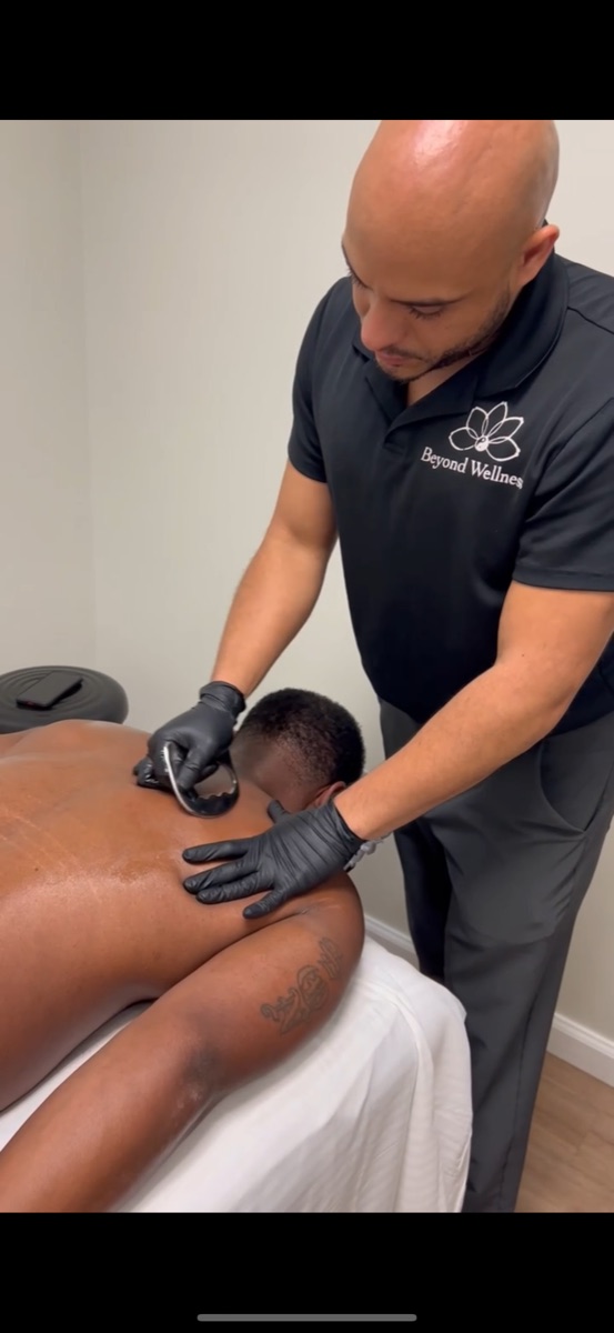 Gua sha blading treatment on a patient's back